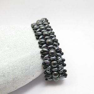 Hand woven bracelet with dark grey Swarovski pearls